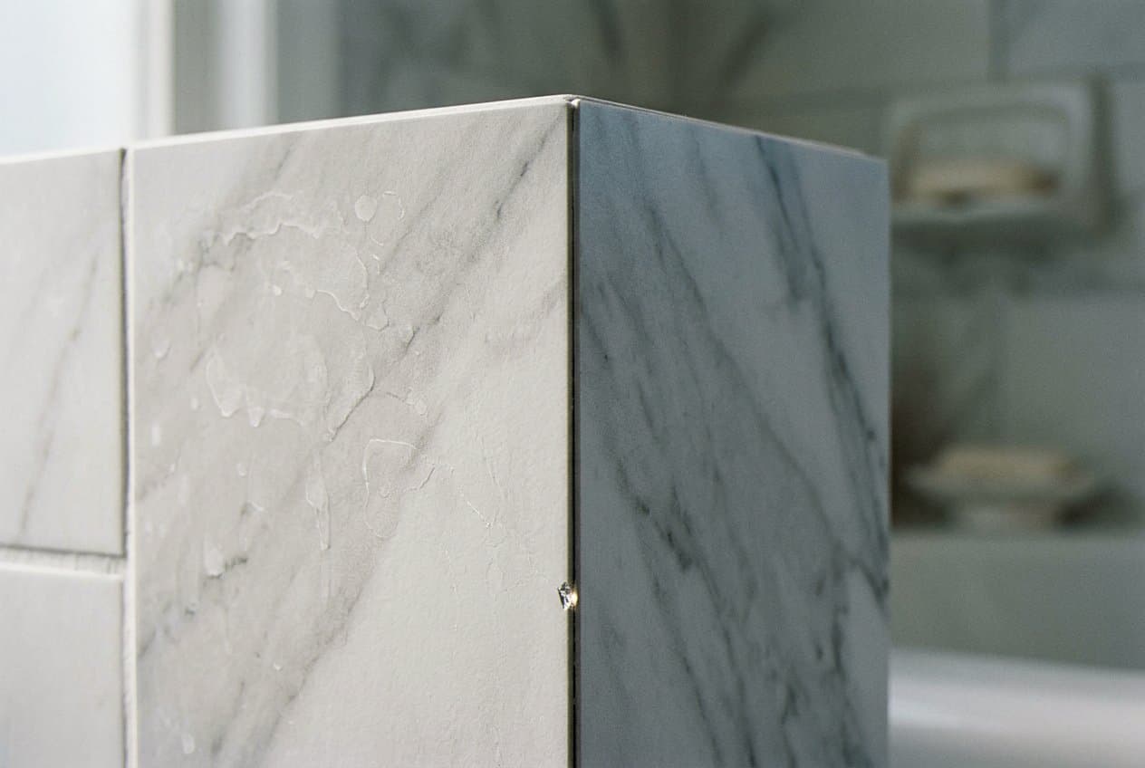 Mitered marble corner seam on a shower wall